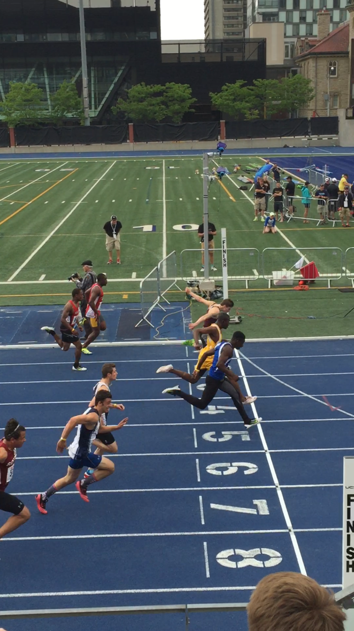 Emmanuelle Ajiroba of St. Augustine (foreground) nips Frontenac's Cole Horsman (top) for the gold medal in the midget boys 100 metre final at OFSAA — Tom Adair photo